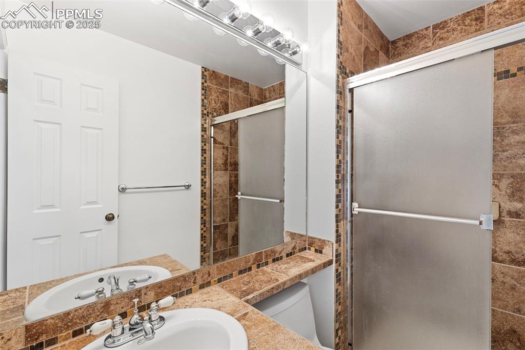 Image 18 of 27: Full bath featuring a shower stall, vanity, and a bathtub