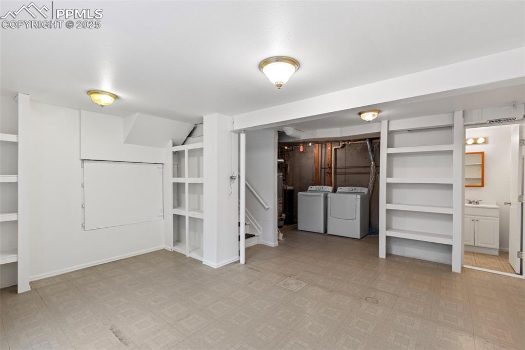 Image 22 of 27: Finished basement with separate washer and dryer and light floors