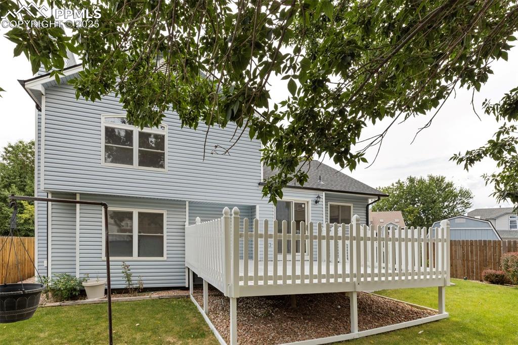 Image 27 of 27: Rear view of house featuring a wooden deck