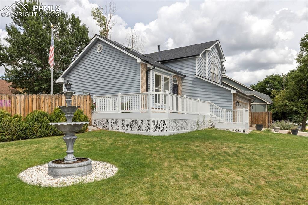 Image 3 of 27: Back of property featuring a wooden deck