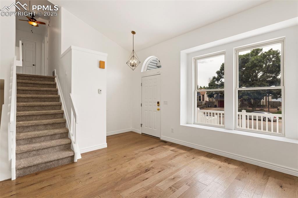 Image 5 of 27: Entrance foyer featuring vaulted ceiling, light wood-type flooring, stairs,