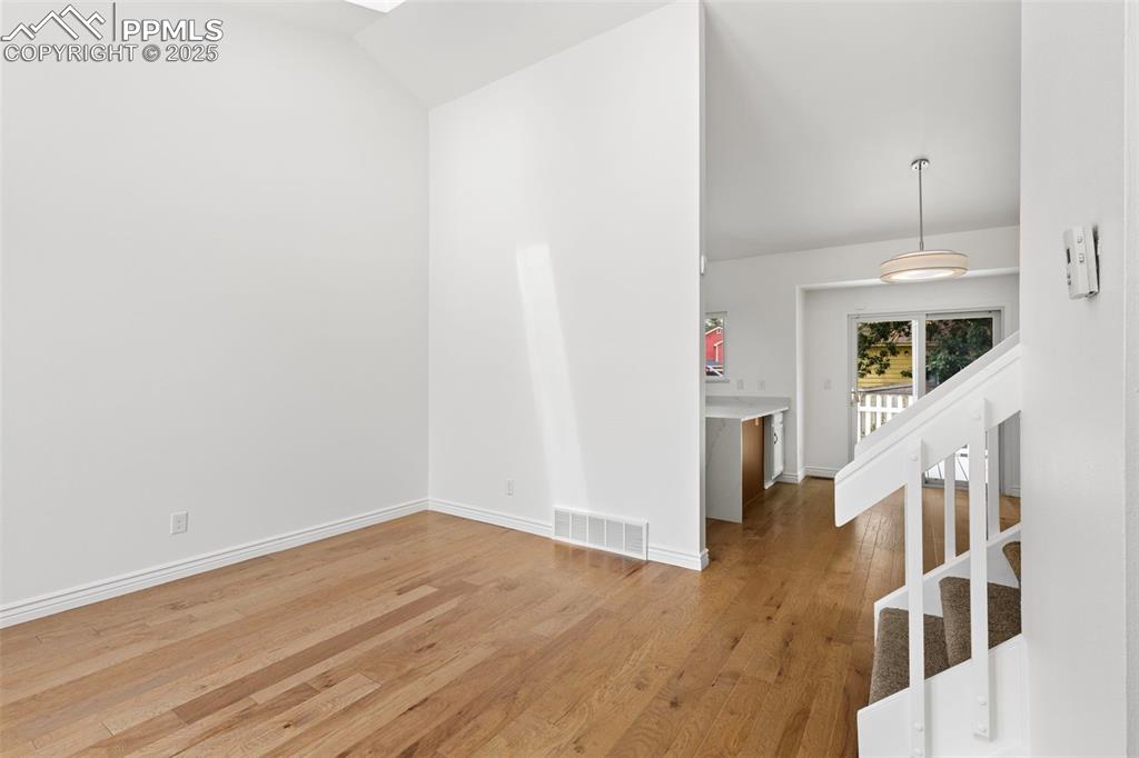 Image 6 of 27: Empty room with light wood-style floors and baseboards