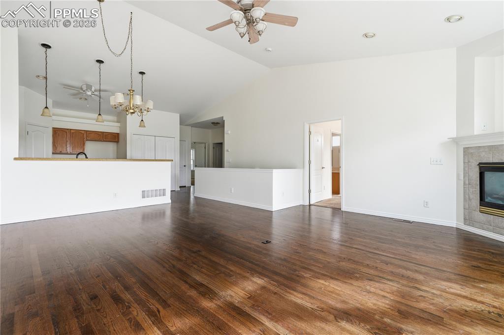 Image 10 of 41: Family room and dining area features newly refinished hardwood floors and f