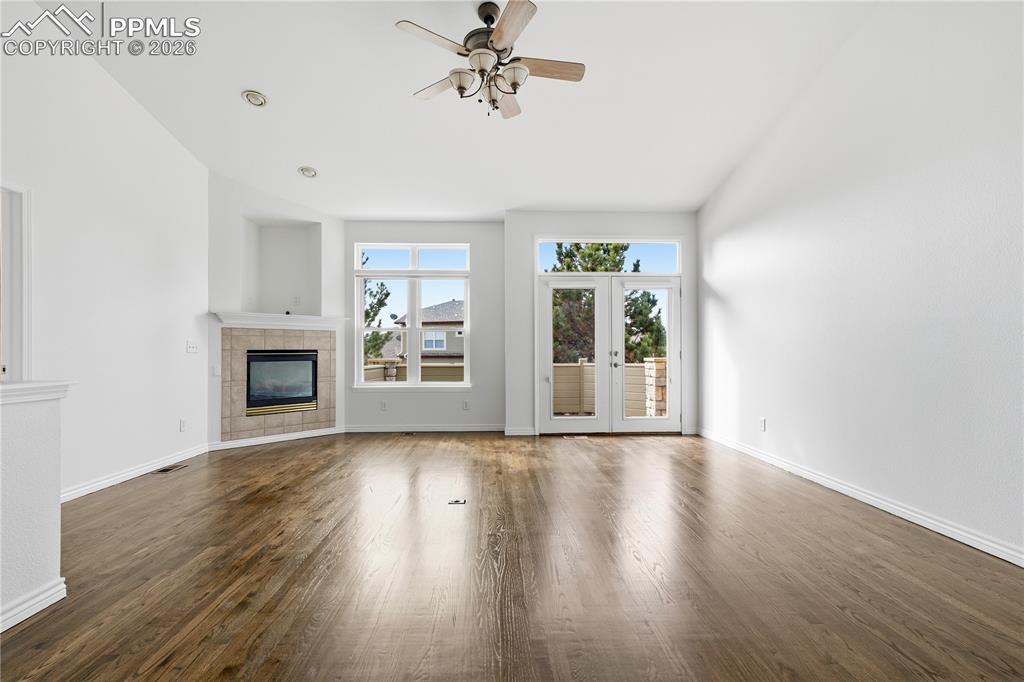 Image 8 of 41: Family room features newly refinished hardwood floors and fresh paint
