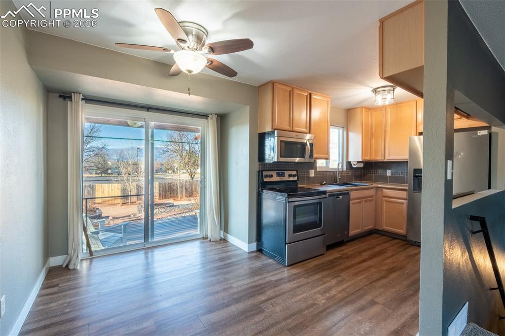 Image 5 of 40: Dining area with walk out/kitchen - main