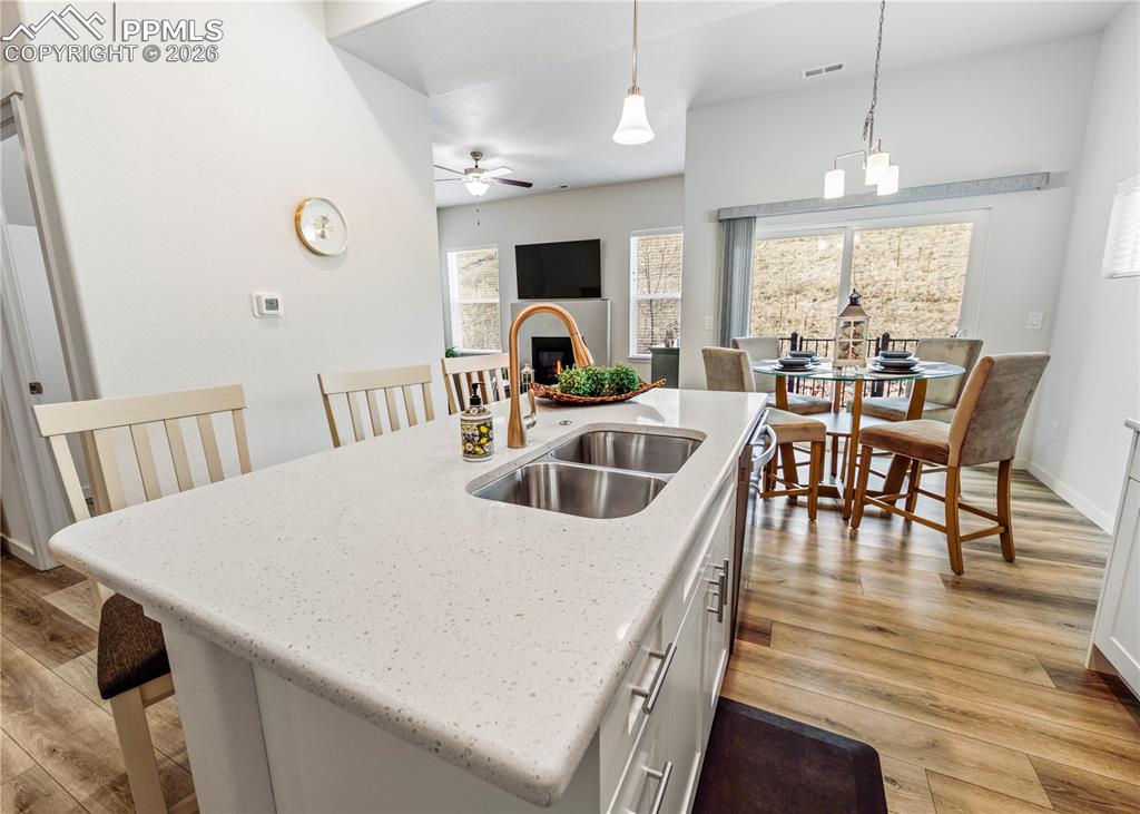 Image 11 of 46: Kitchen with a kitchen breakfast bar, light wood-type flooring, an island w