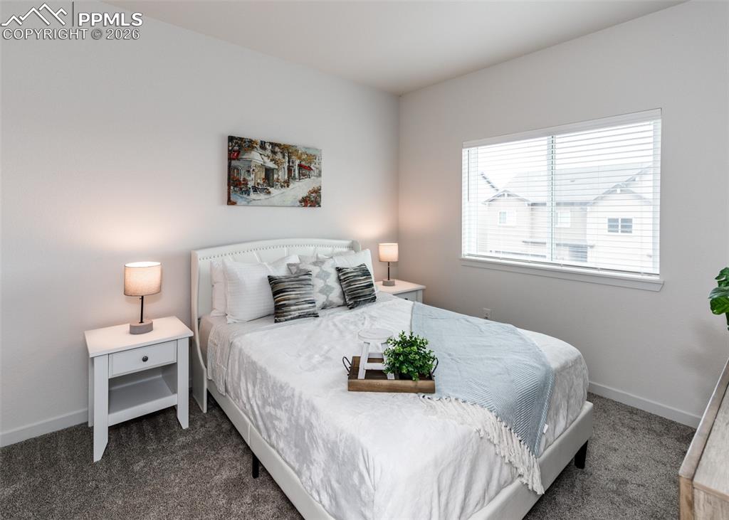Image 33 of 46: Bedroom featuring baseboards and dark colored carpet