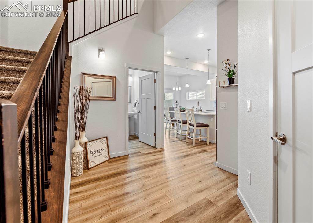 Image 4 of 46: Entryway with light wood-style flooring and recessed lighting