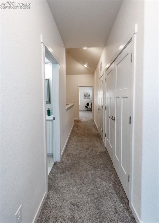 Image 42 of 46: Hallway with carpet flooring and baseboards