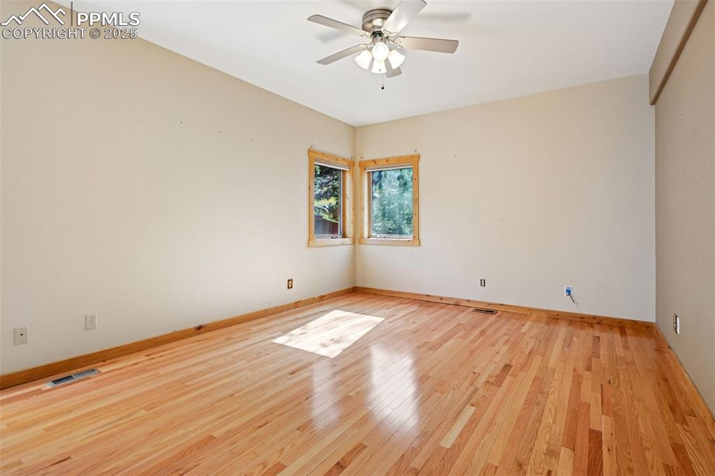 Image 23 of 42: Spare room with light wood-type flooring and a ceiling fan