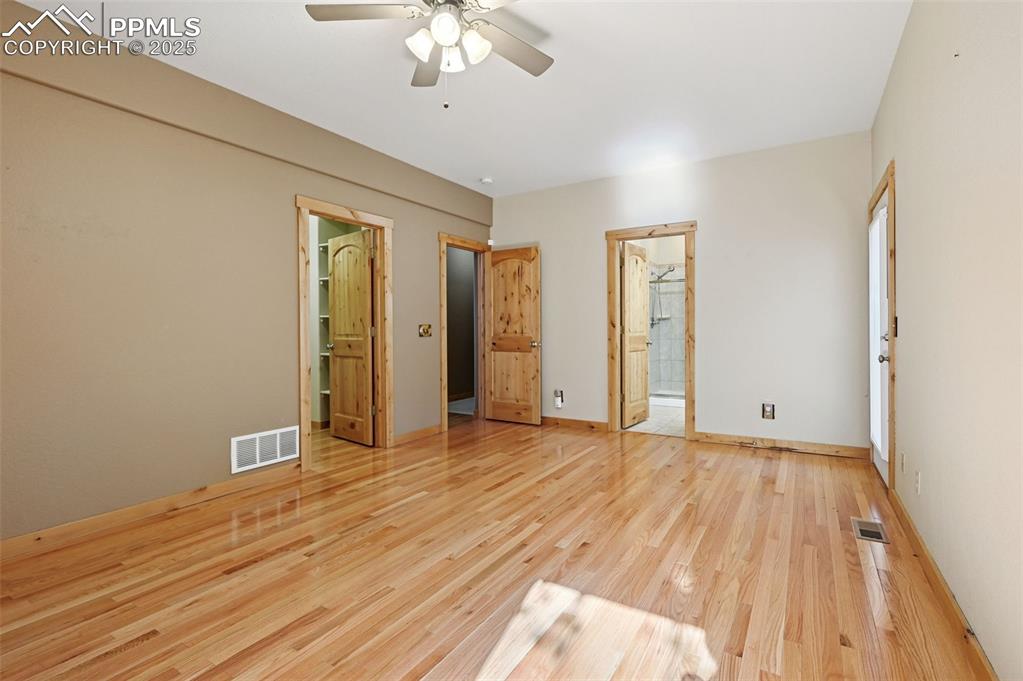 Image 25 of 42: Unfurnished bedroom featuring light wood-style flooring, ceiling fan, and e