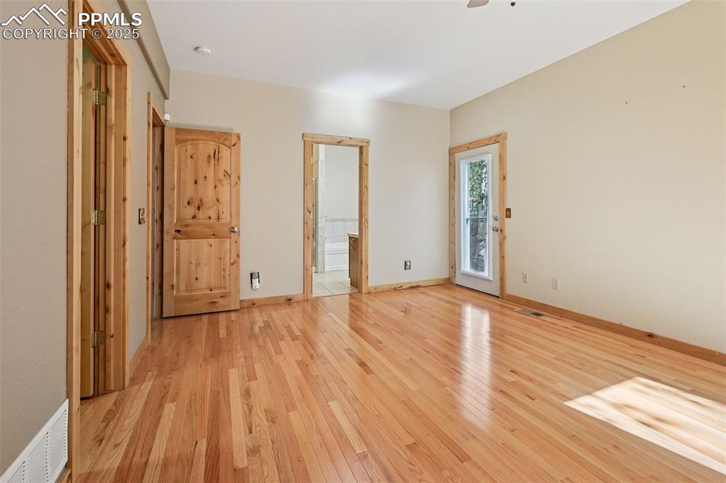 Image 26 of 42: Unfurnished bedroom with light wood finished floors, ceiling fan, access to