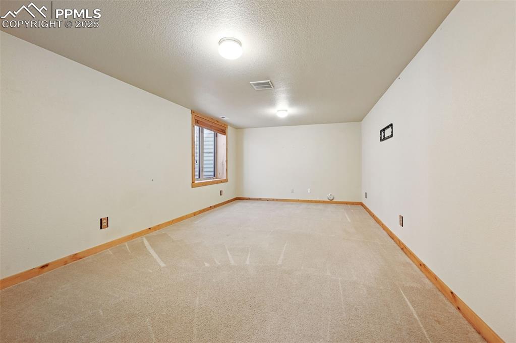 Image 5 of 42: Spare room featuring carpet and a textured ceiling