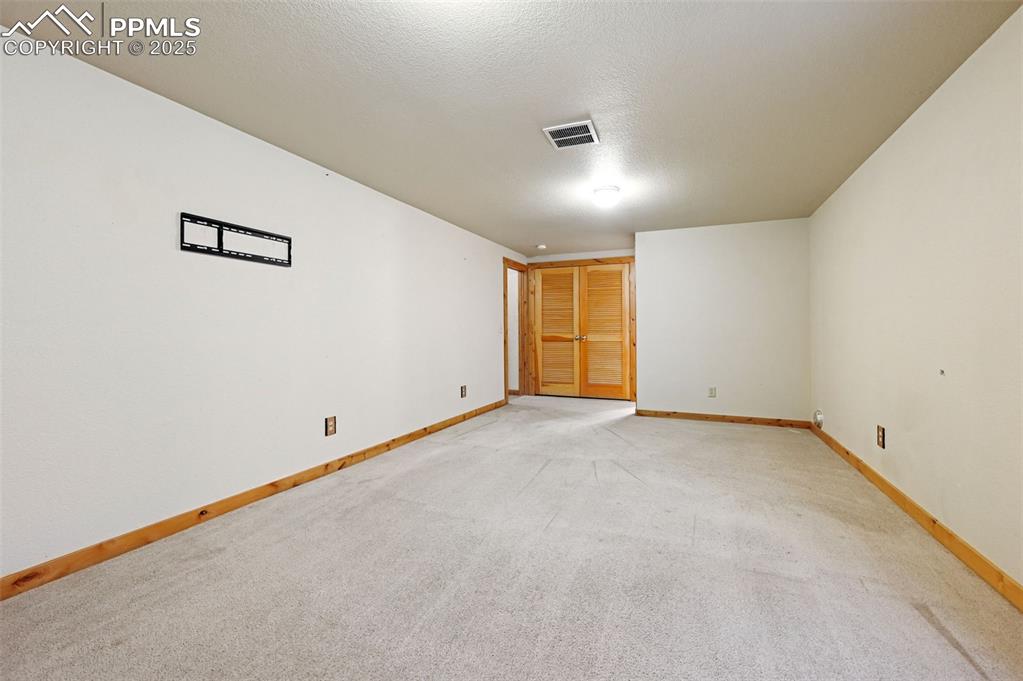 Image 7 of 42: Empty room with light colored carpet and a textured ceiling