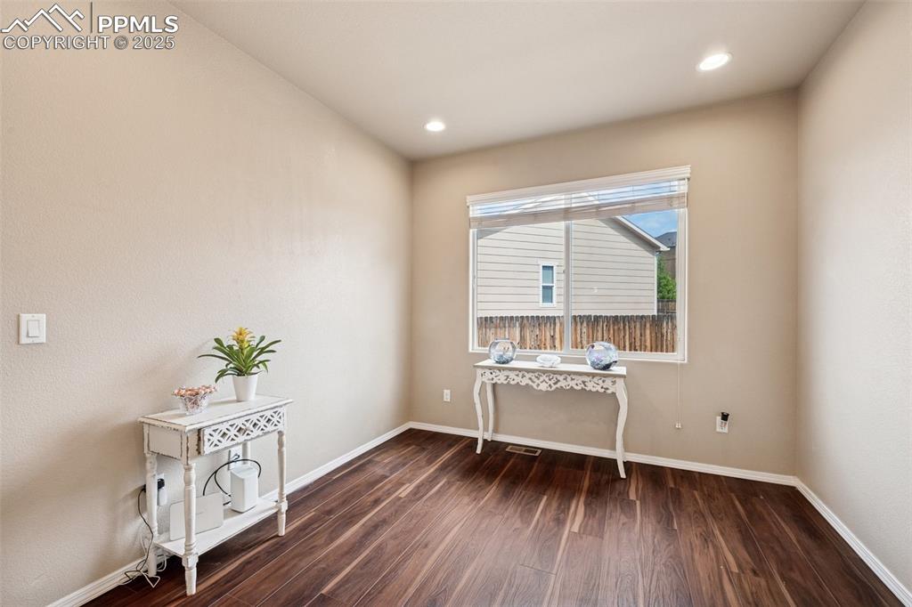 Image 17 of 46: Office with wood-style floors and recessed lighting