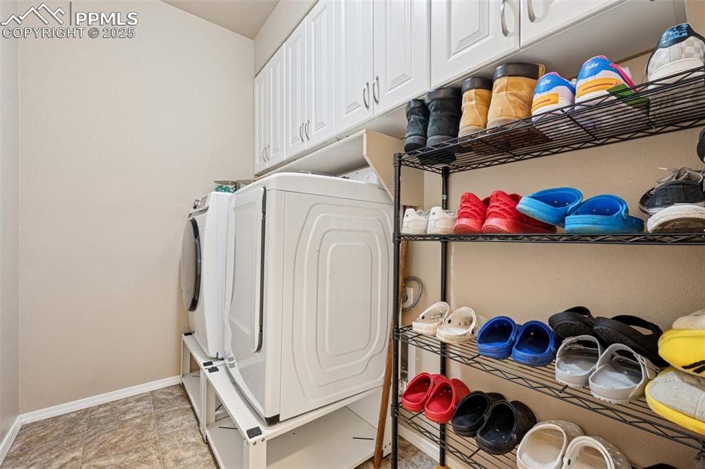 Image 20 of 46: Laundry area featuring washer / dryer and cabinet space