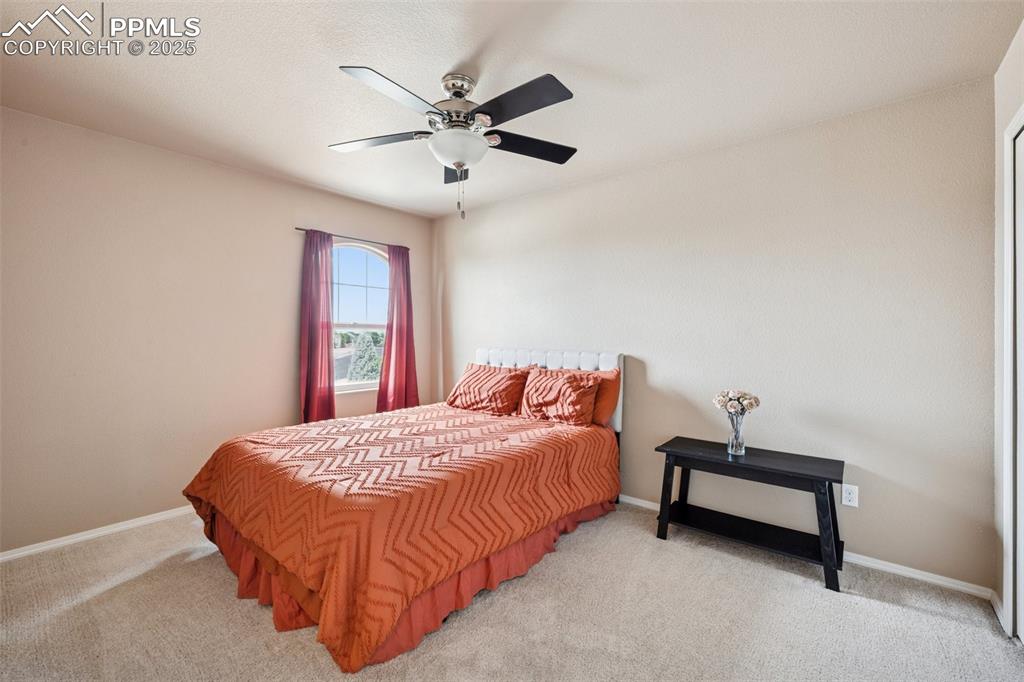 Image 28 of 46: Bedroom with unobstructed views of Pikes Peak Mountains with light colored