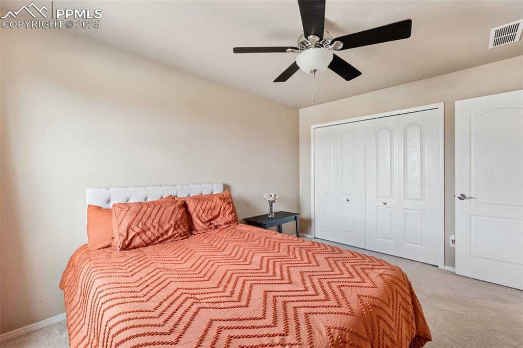 Image 29 of 46: Bedroom featuring light carpet, a closet, and ceiling fan