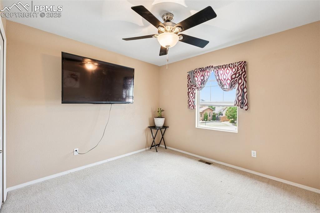 Image 30 of 46: Bedroom with unobstructed views of Pikes Peak Mountains with light colored