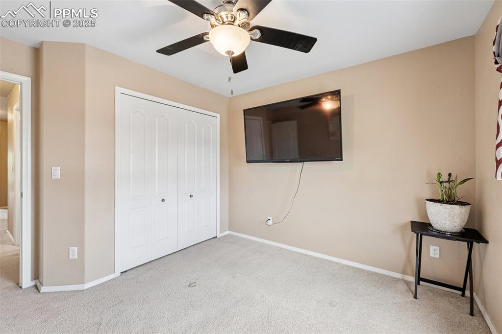 Image 31 of 46: Unfurnished bedroom featuring carpet flooring, a closet, and a ceiling fan