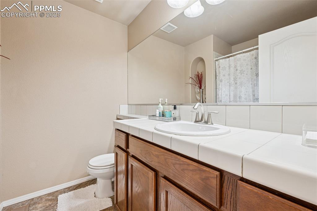 Image 32 of 46: Bathroom featuring shower/tub, toilet and vanity