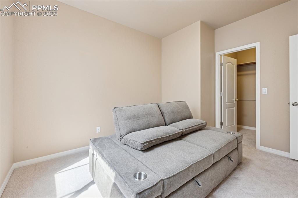 Image 34 of 46: Living area featuring light colored carpet