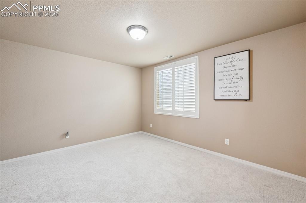 Image 37 of 46: Bedroom featuring carpet floors, baseboards and lighting