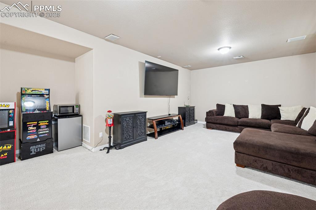 Image 38 of 46: Second living area in basement featuring carpet flooring and baseboards