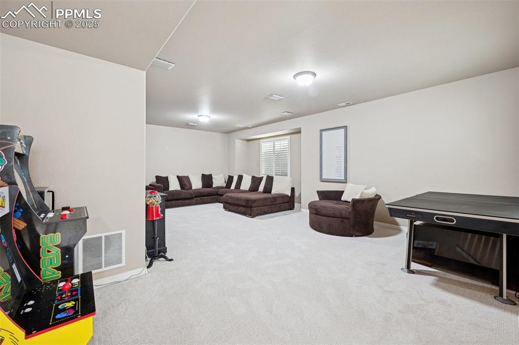 Image 39 of 46: Spacious game room with the arcade games