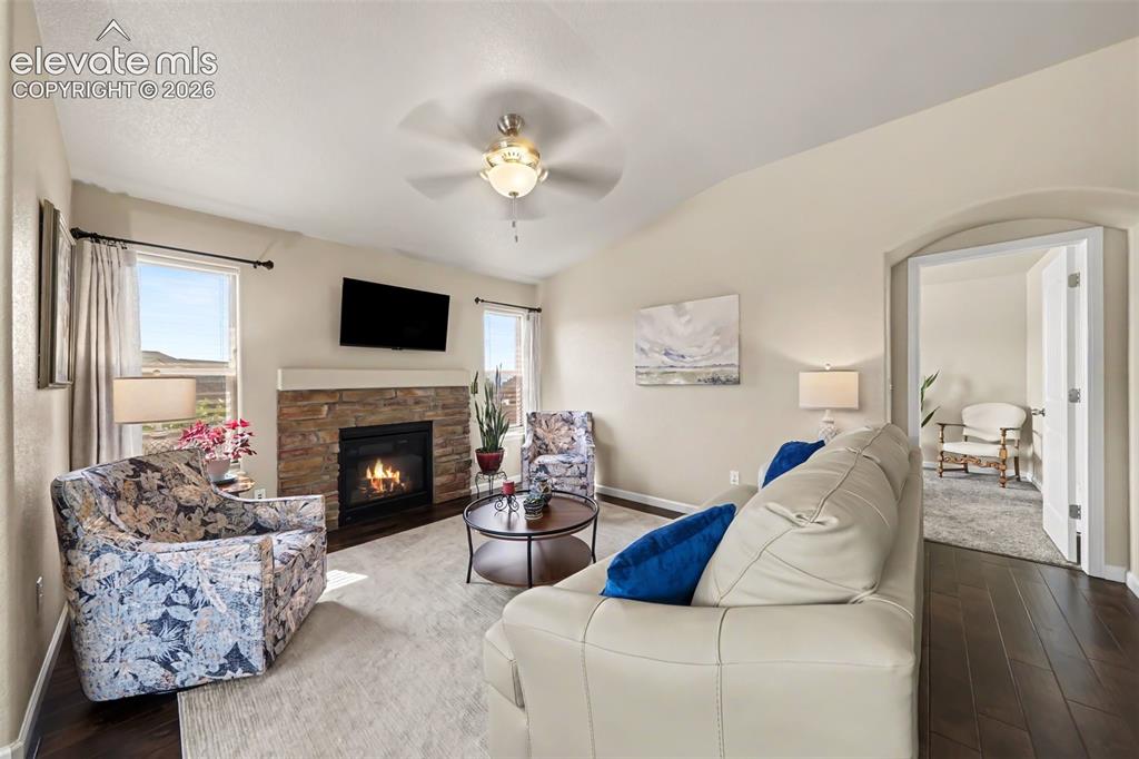 Image 10 of 32: The welcoming living room offers a cozy gas fireplace, comfortable carpet f
