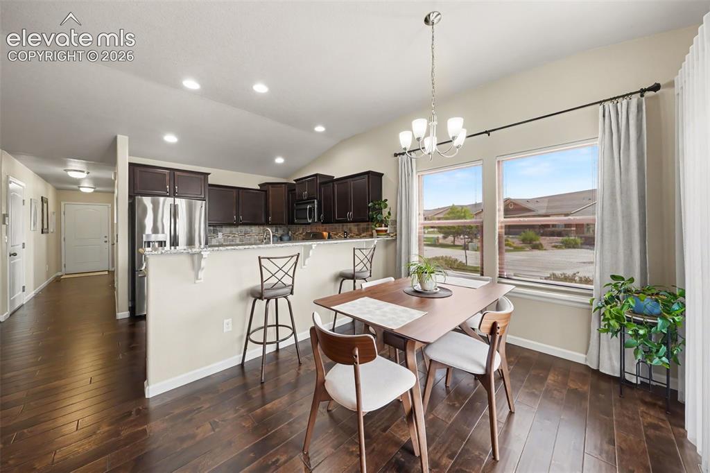 Image 11 of 32: Elegant dining room featuring a walkout to the partially covered patio, cre