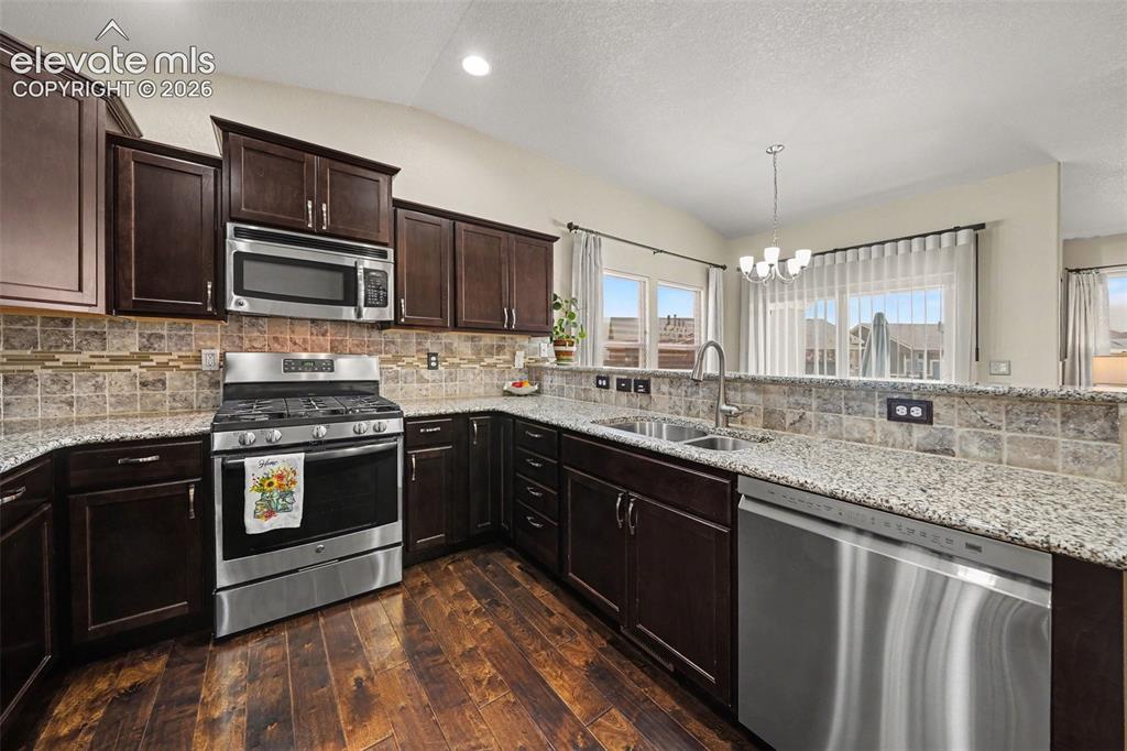 Image 13 of 32: Sleek stainless-steel appliances, and a 5-burner gas stove