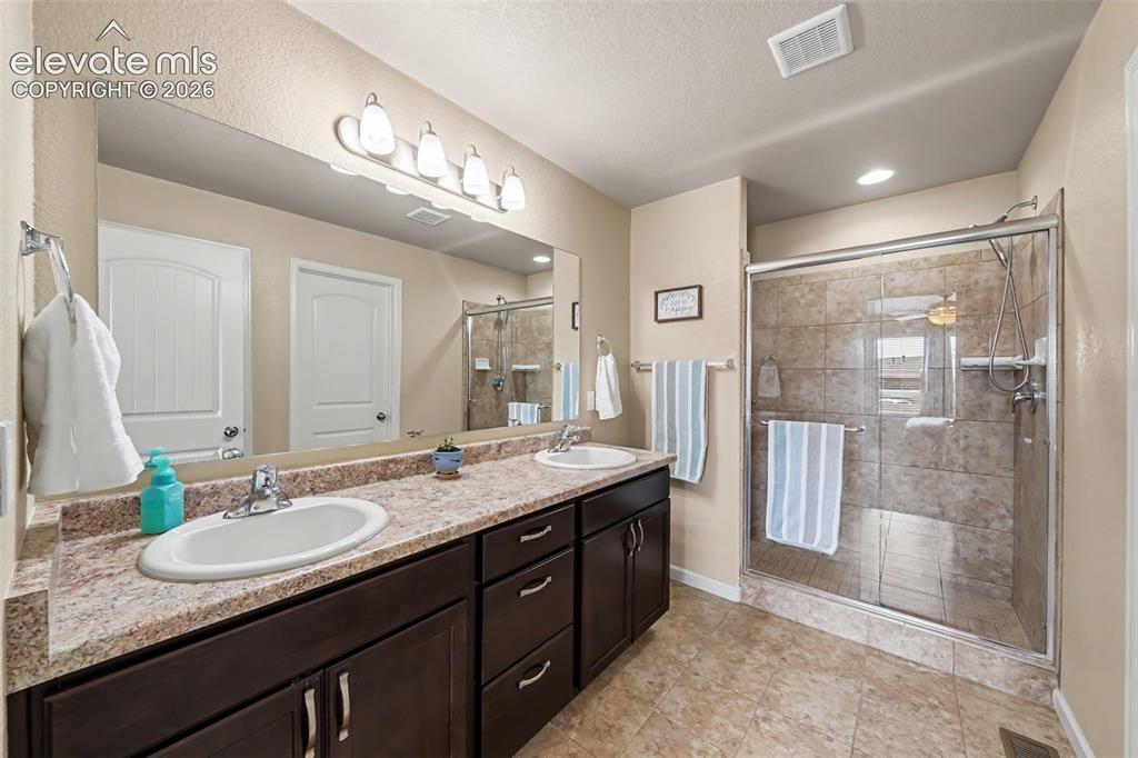 Image 15 of 32: Beautiful primary bathroom featuring a double vanity, oversized walk-in sho