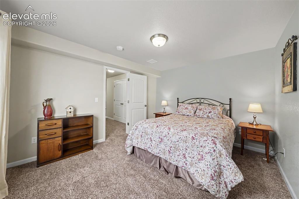 Image 16 of 32: Spacious basement secondary bedroom, offering flexibility for guests, a hom