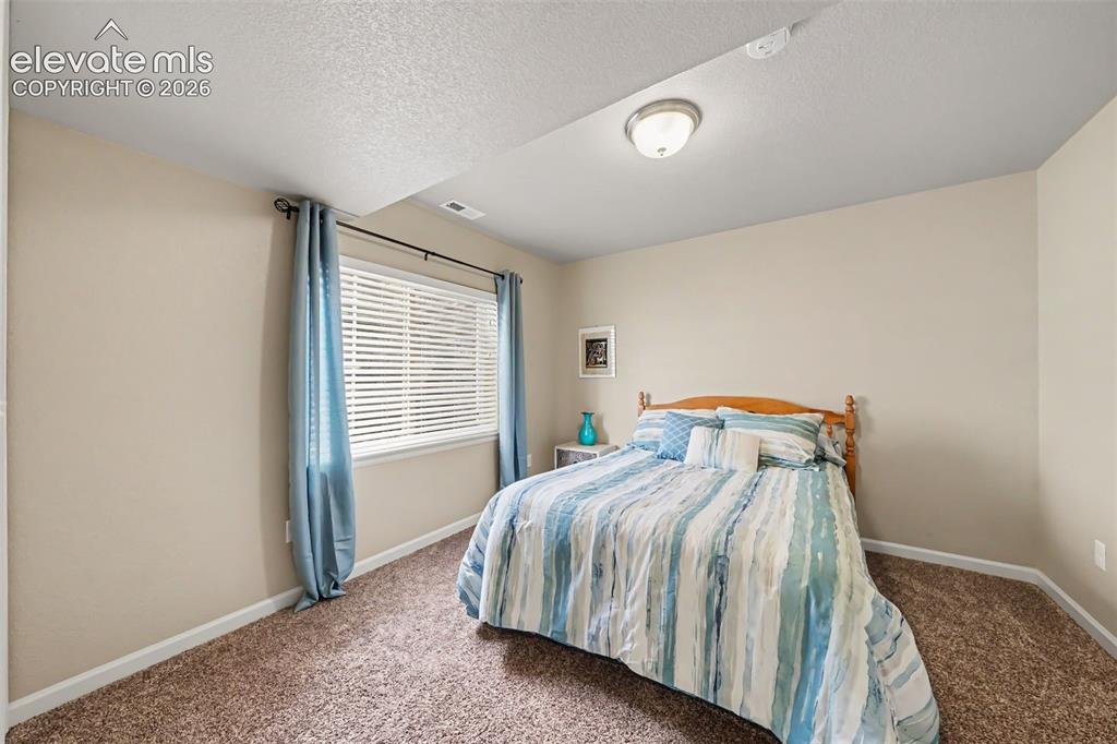 Image 20 of 32: Well-appointed third bedroom located in the finished basement, providing ad