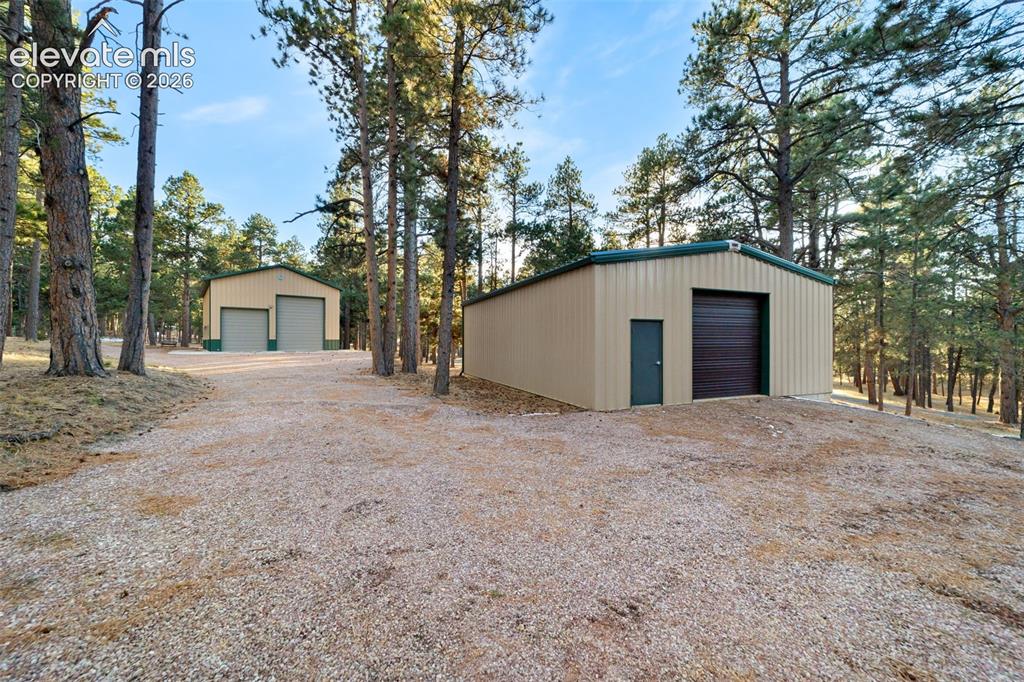 Image 3 of 50: Equipment, garage and r v garage with drive through doors, water, electric