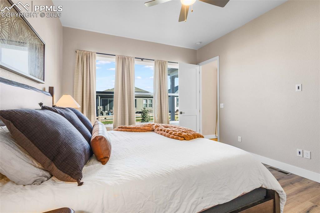 Image 10 of 38: main level primary bedroom with walk in closet and ensuite bathroom