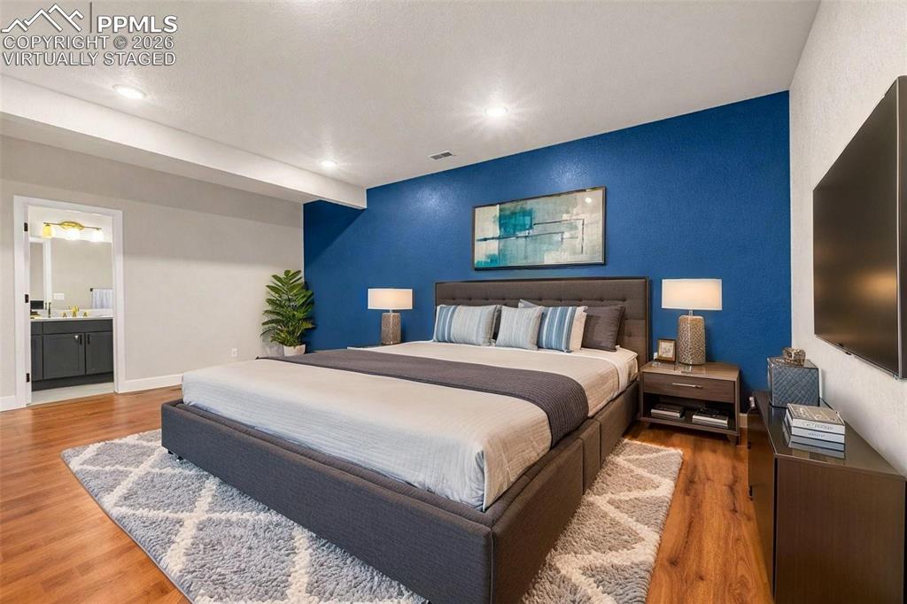 Image 22 of 38: huge lower level bedroom w/ ensuite full bathroom - virtually staged