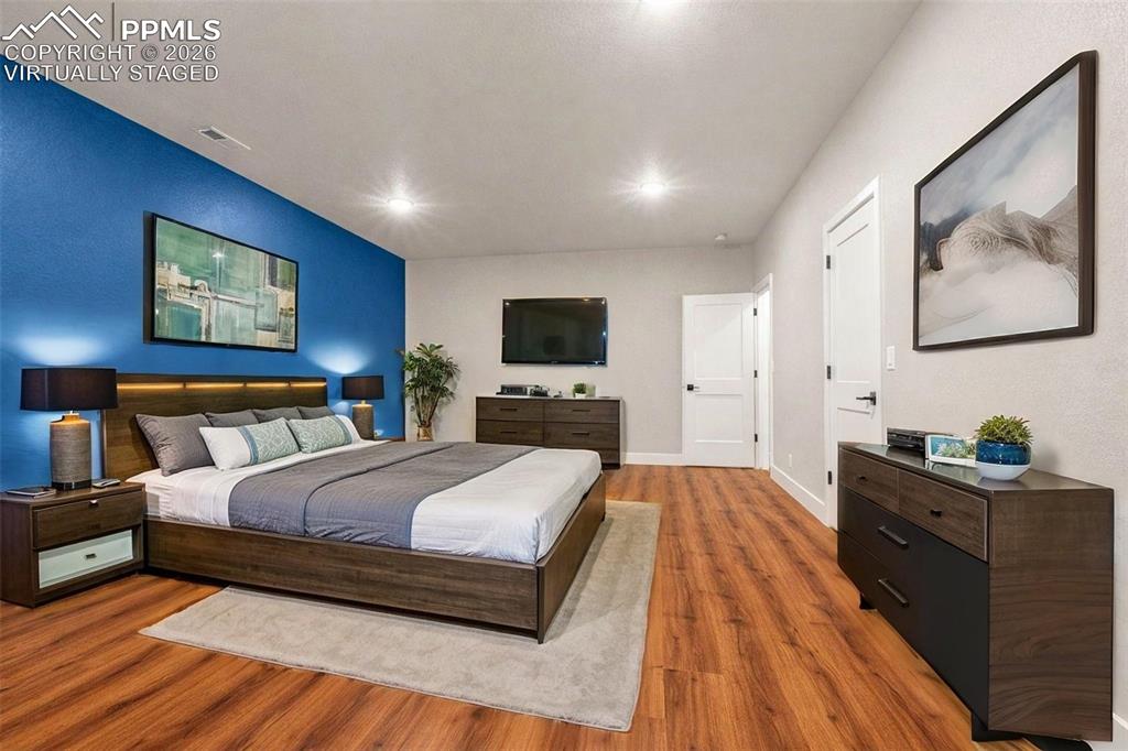 Image 23 of 38: huge lower level bedroom w/ ensuite full bathroom - virtually staged