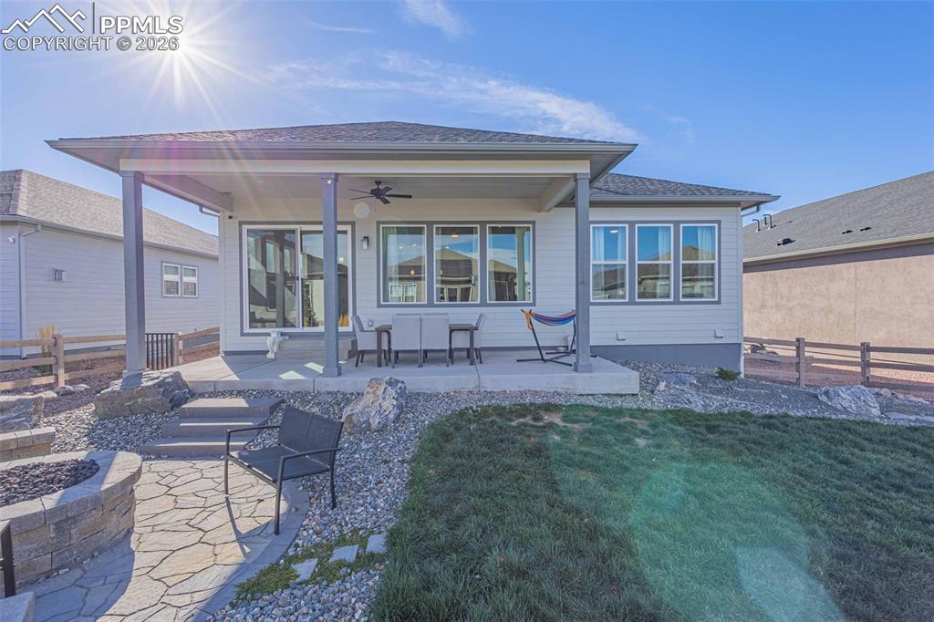 Image 29 of 38: Back of property with a patio, ceiling fan, and a fire pit