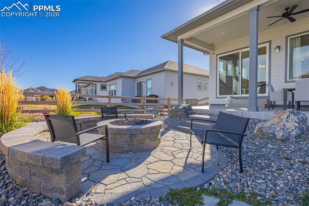 Image 31 of 38: View of patio / terrace featuring a fire pit and ceiling fan