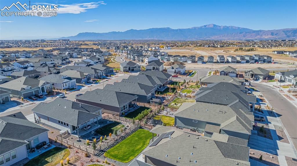 Image 35 of 38: Aerial perspective of suburban area featuring a mountainous background