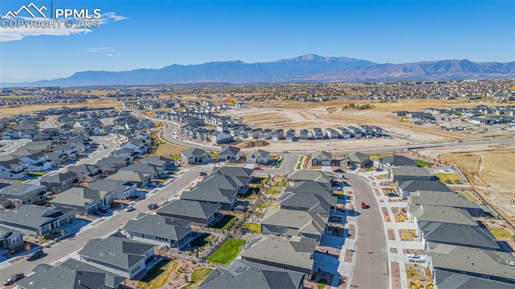 Image 36 of 38: Aerial perspective of suburban area with a mountain backdrop