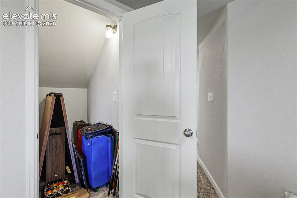 Image 22 of 34: Storage under stairs in family room