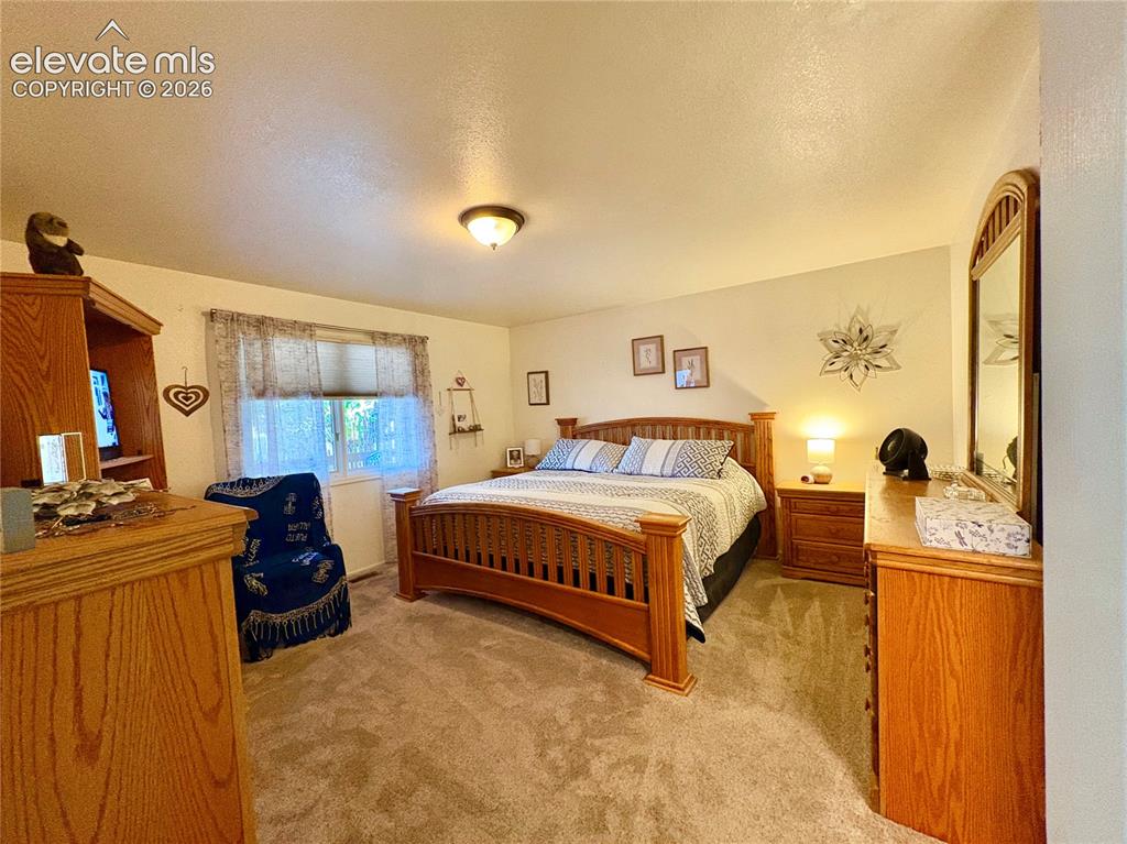 Image 16 of 28: Neutral-toned wall paint with a window and a ceiling-mounted light fixture