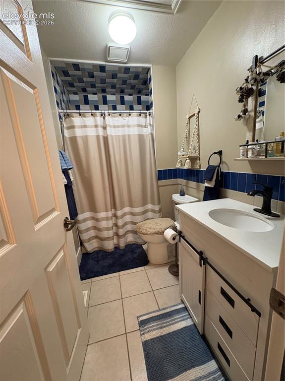 Image 18 of 28: White vanity with a single basin sink, matte black faucet, and barn-door st