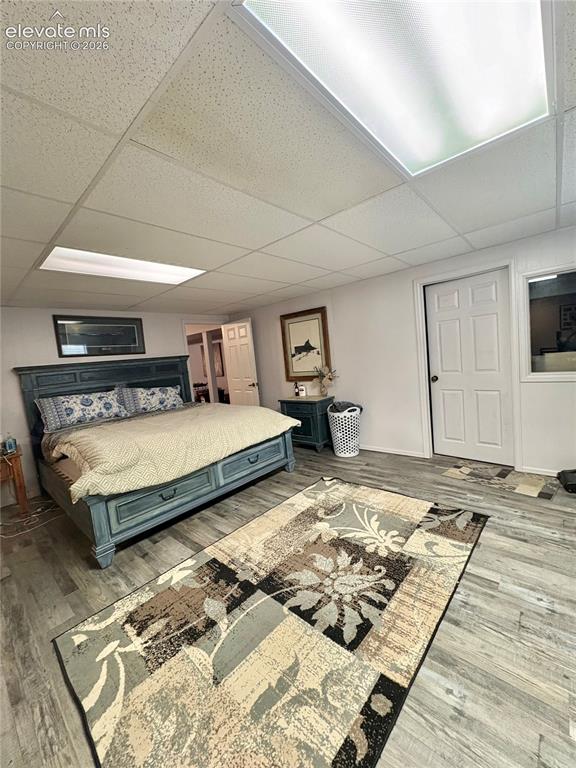Image 23 of 28: Recessed lighting, wood-finish flooring, drop ceiling, interior door with a