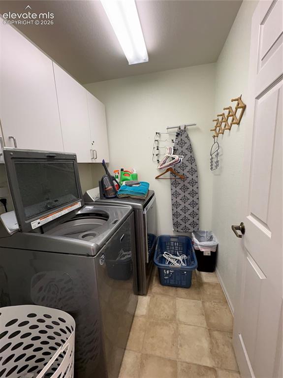Image 7 of 28: Built-in white cabinetry, light-toned walls, and a white paneled door with 
