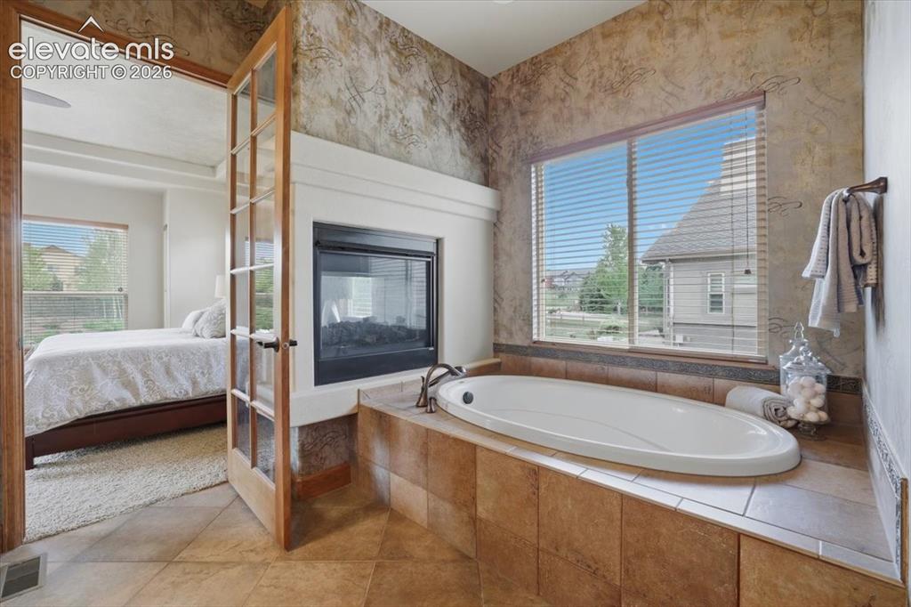 Image 14 of 32: Double-sided fireplace with Soaking Tub!