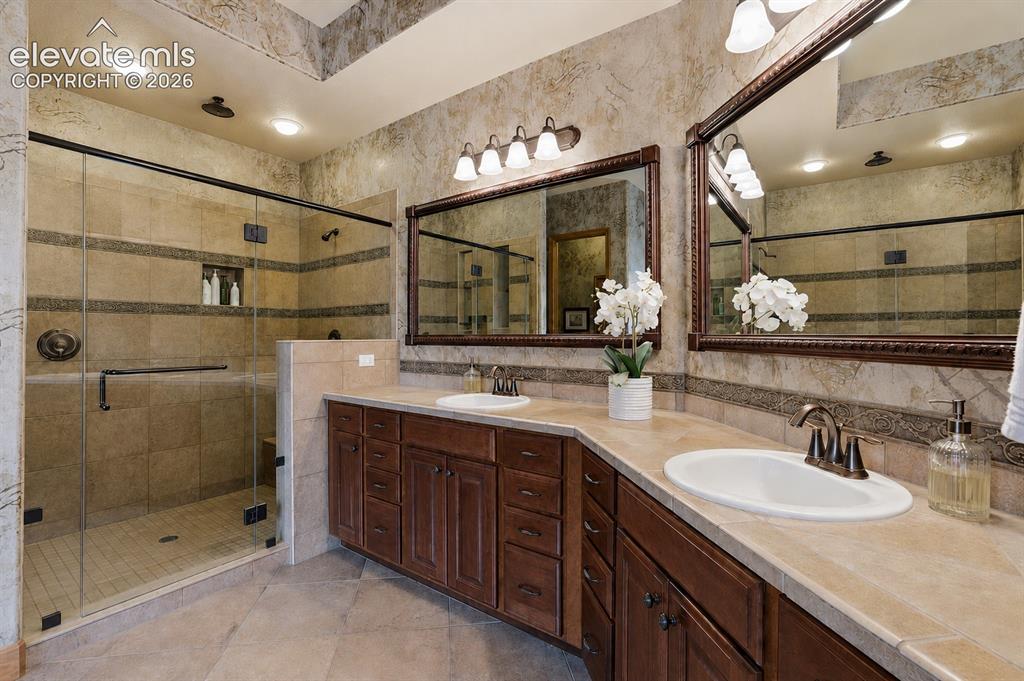 Image 15 of 32: Double Vanity, Glass Shower with Bench and multiple Shower Heads!